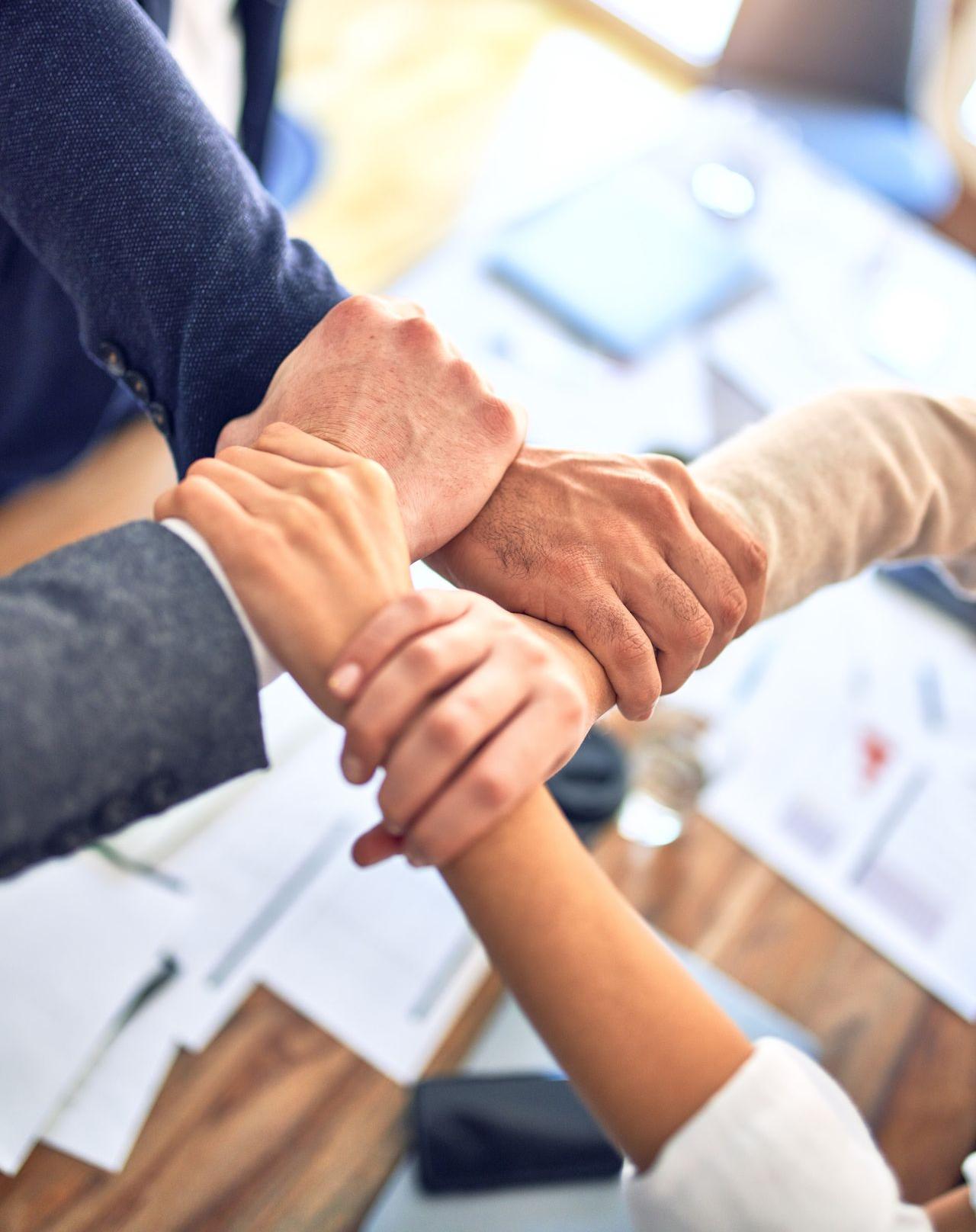 person in black long sleeve shirt holding persons hand